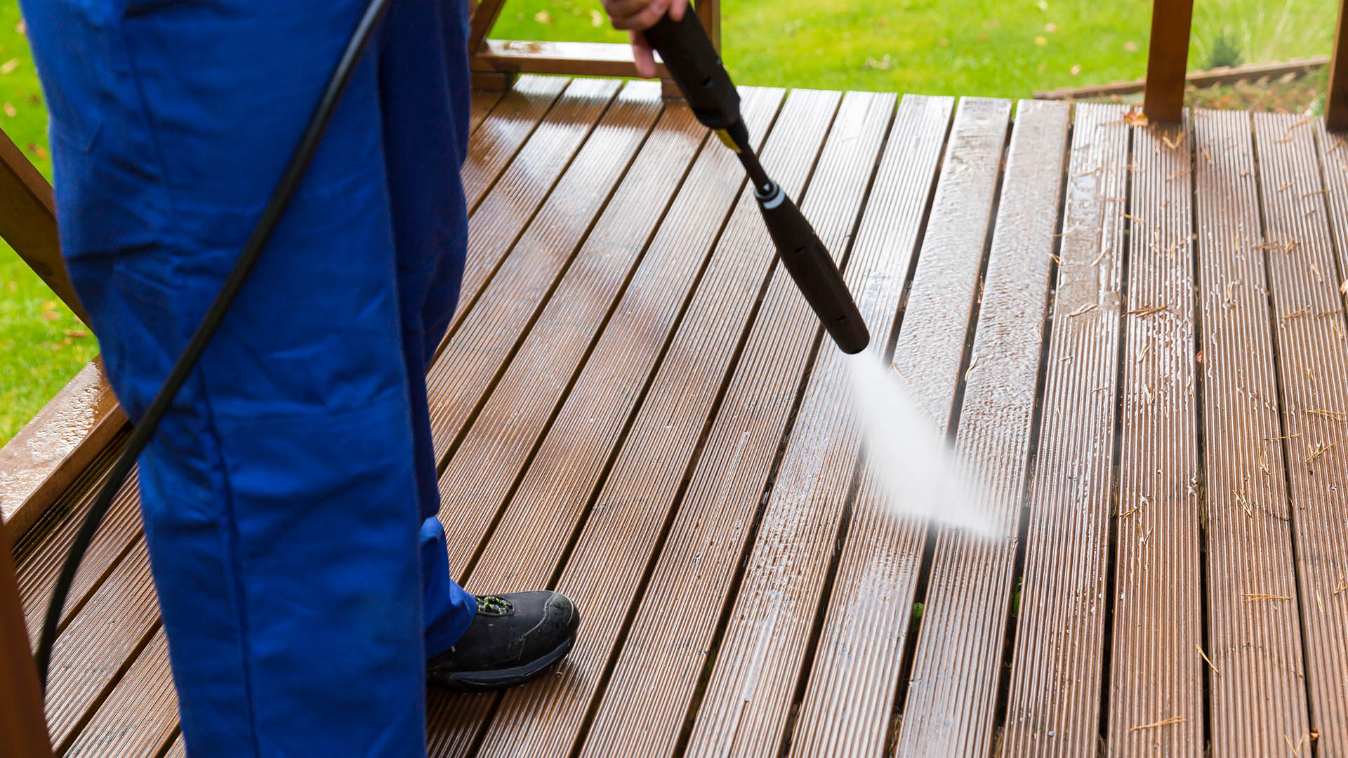 Pressure washing service cleaning a deck.